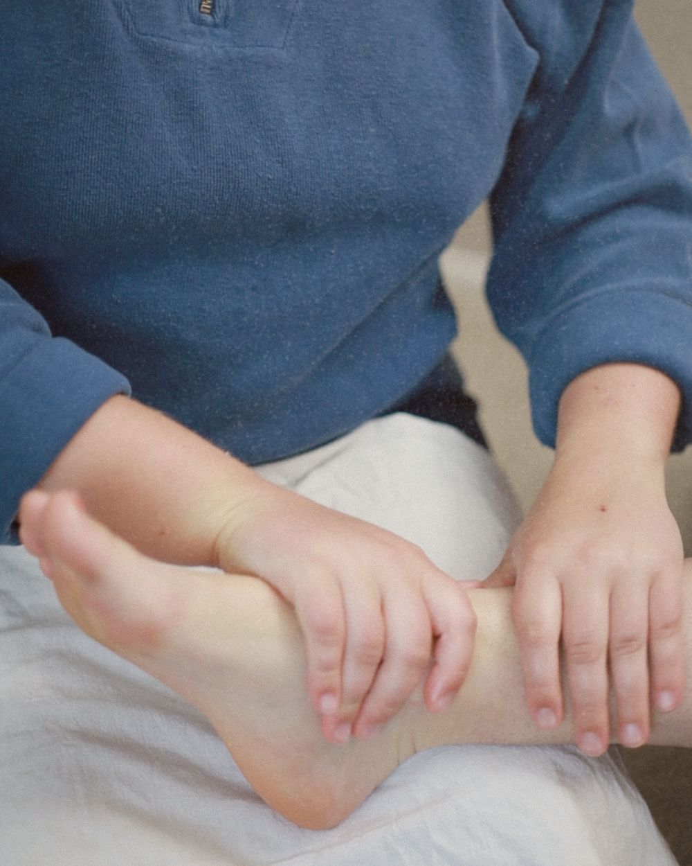 Hands gently working during a foot zone session
